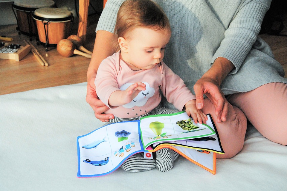 Baby and parent reading together