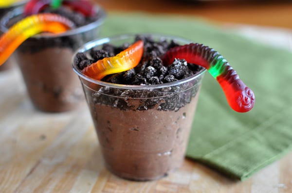 Pudding with crushed oreos and gummy worms on top 