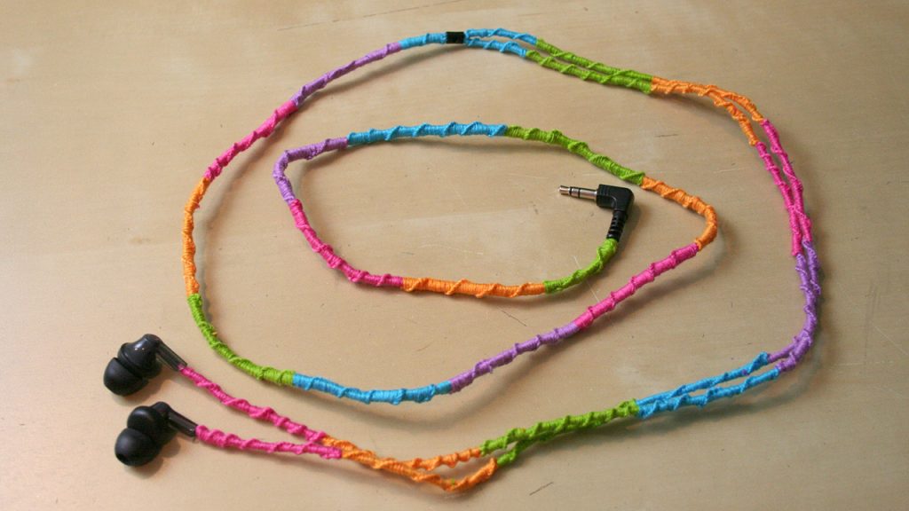 A pair of headphones with string wrapped around the cords