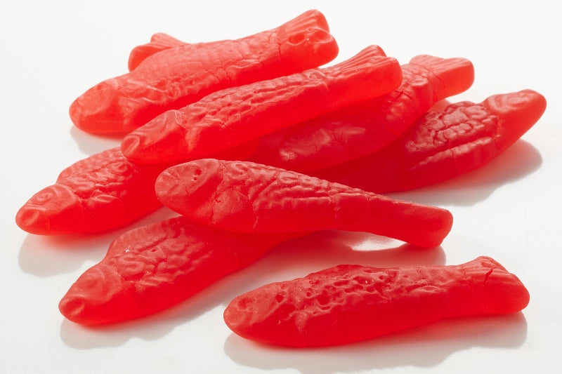 A pile of red Swedish Fish gummies 