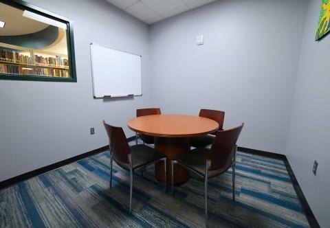 Study Room B with circular table, chairs, and whiteboard
