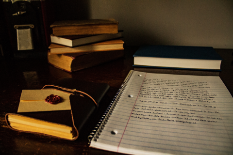 Books and notepad on table