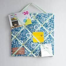 sample memory board with blue fabric and blue ribbon crisscrossing  