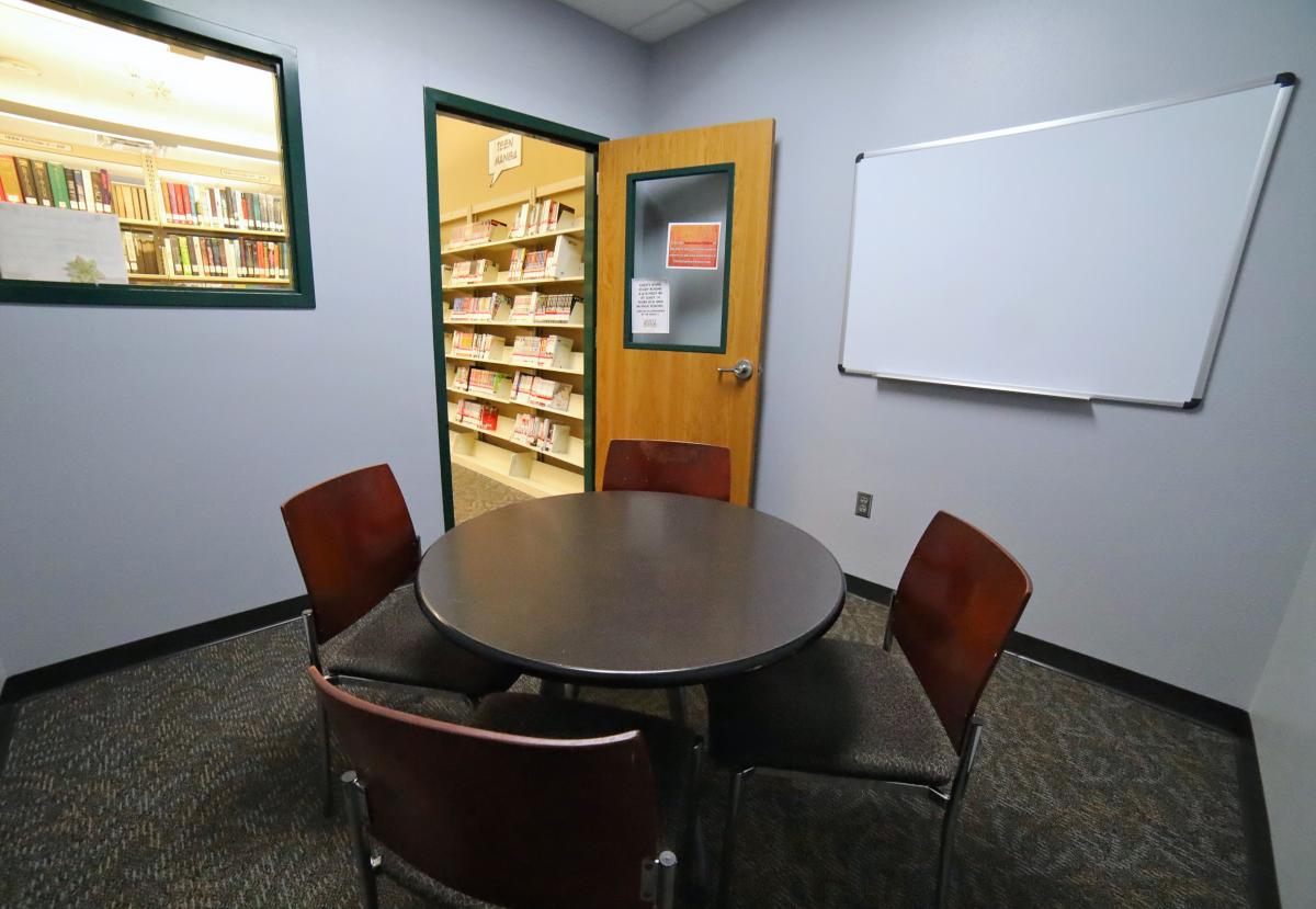 Study Room A with circular table, chairs, and whiteboard