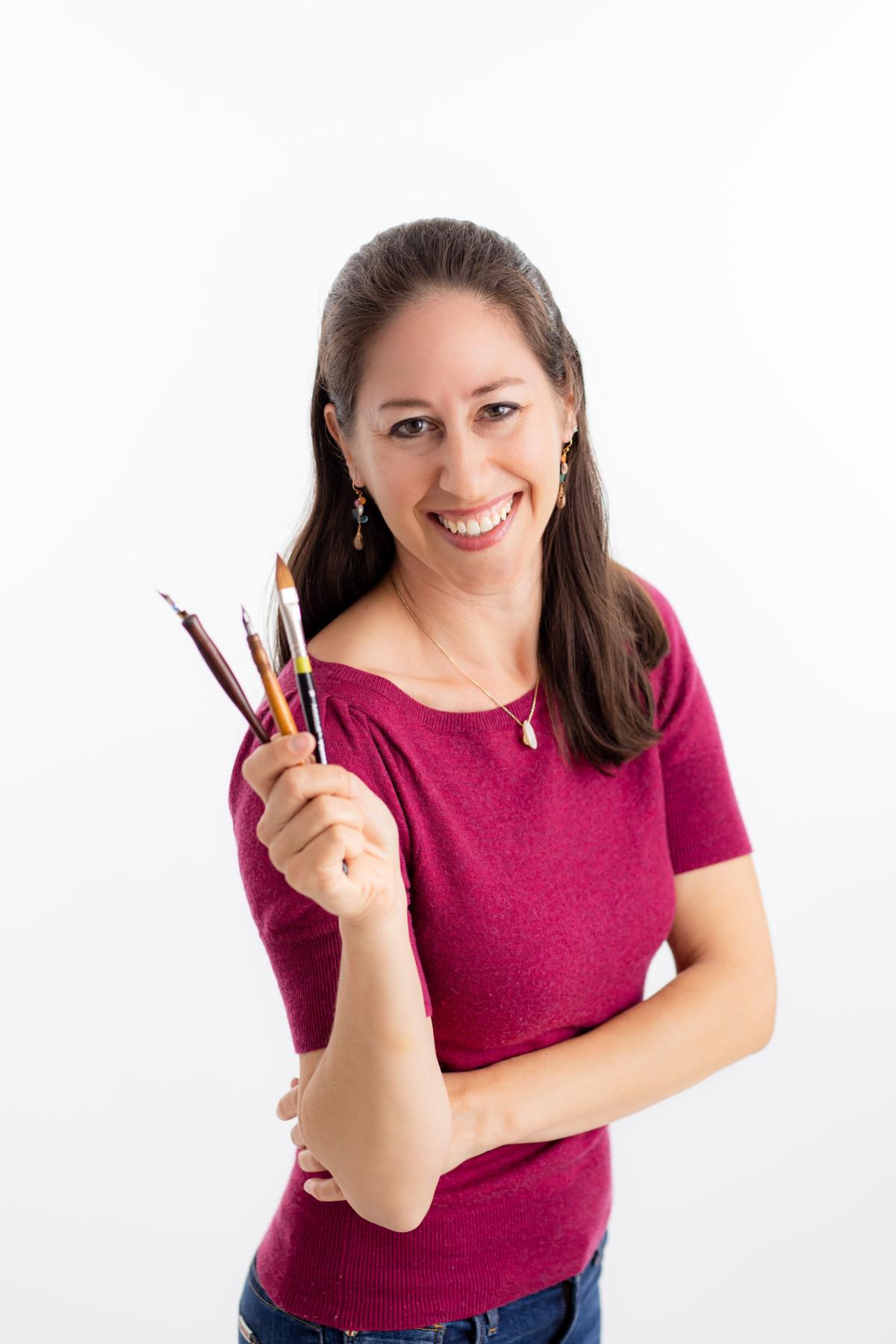 Margot holding calligraphy tools