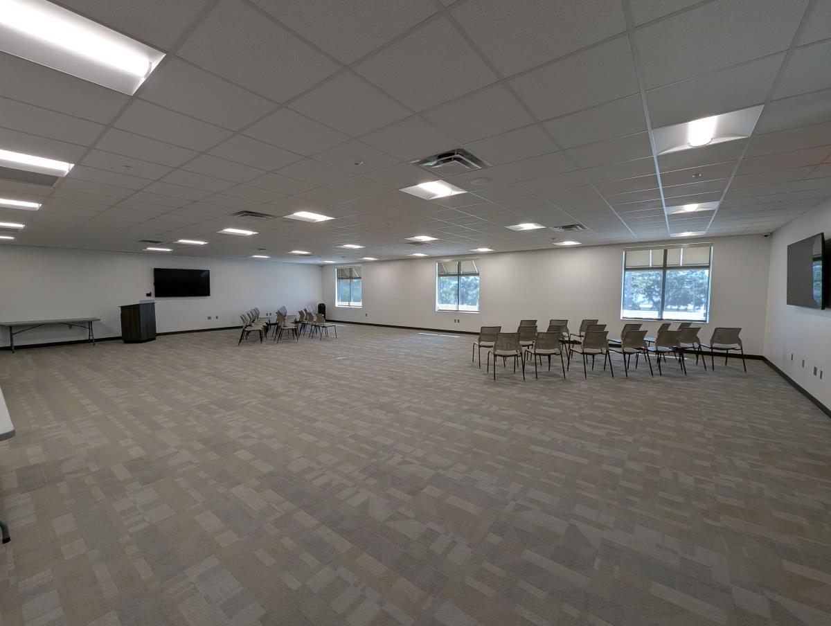 Large meeting room space with tables and chairs.
